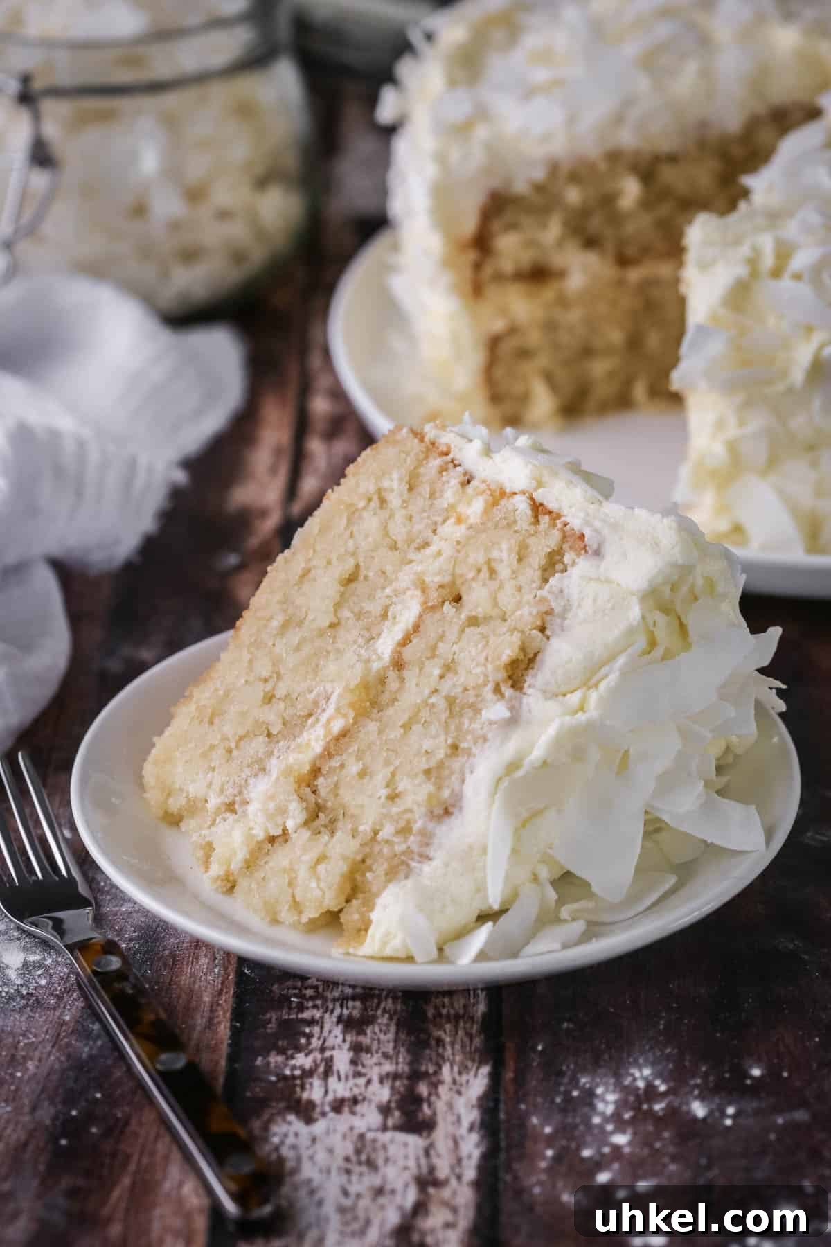 Coconut Cake Without Gluten: Moist Recipe for Allergy-Friendly Celebrations 20 Soft, moist and fluffy slice of gluten-free Coconut Cake on a plate showing the tender crumb.