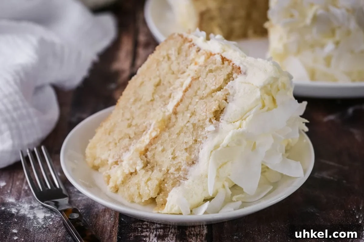 Coconut Cake Without Gluten: Moist Recipe for Allergy-Friendly Celebrations 3 Soft, moist and fluffy slice of gluten-free Coconut Cake on a plate showing the tender crumb.