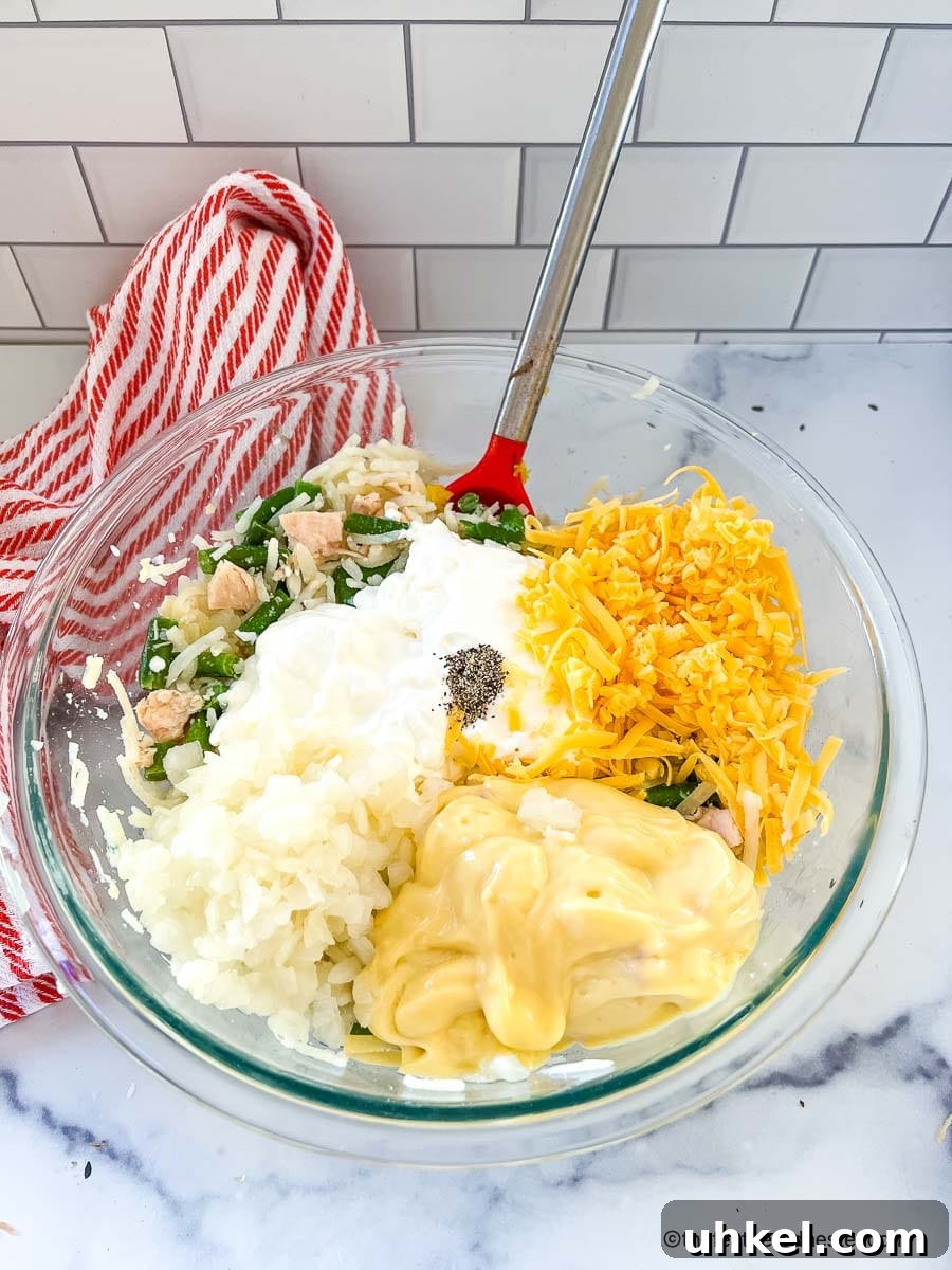 Crispy Hash Brown Chicken Casserole with Cheesy Topping 6 a bowl of chicken and hash brown casserole ingredients.