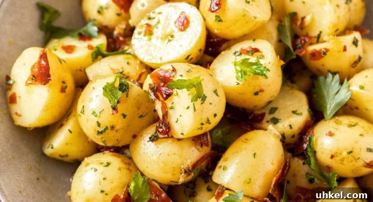 Overhead image of garlic butter potatoes with crispy prosciutto. 