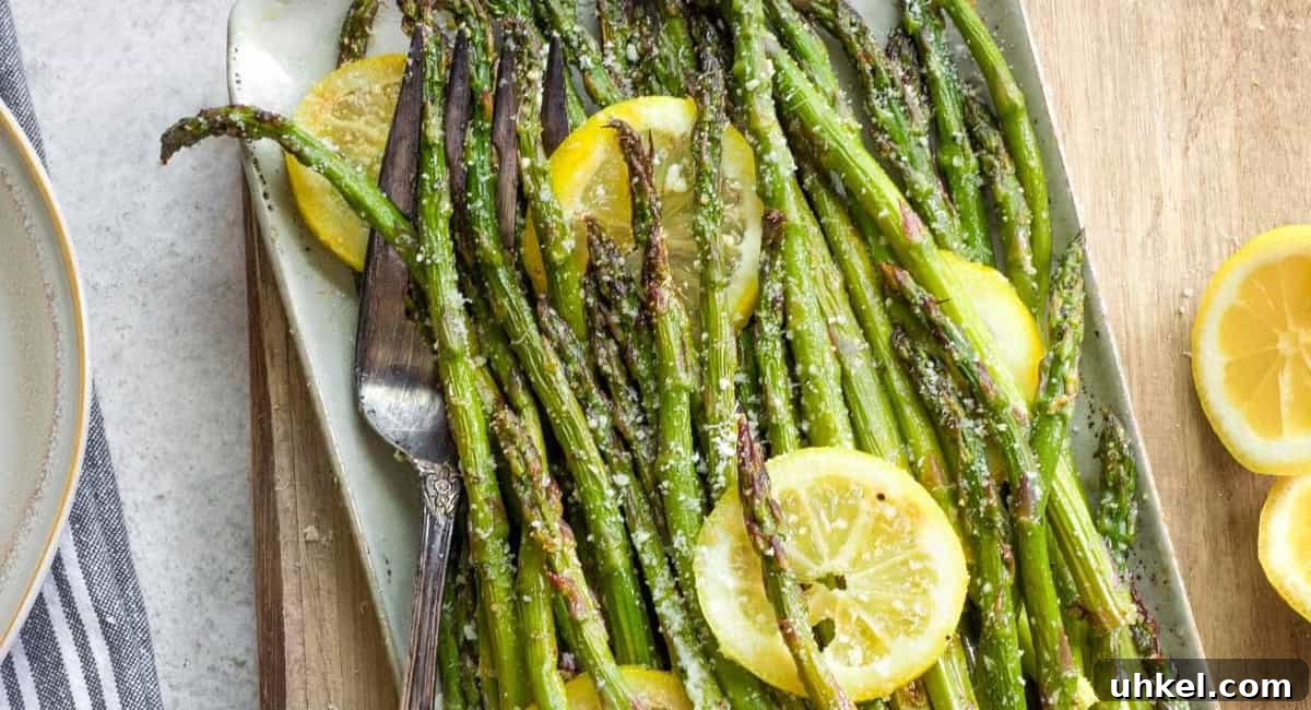 Overhead image of grilled asparagus with parmesan, lemon, and garlic. 