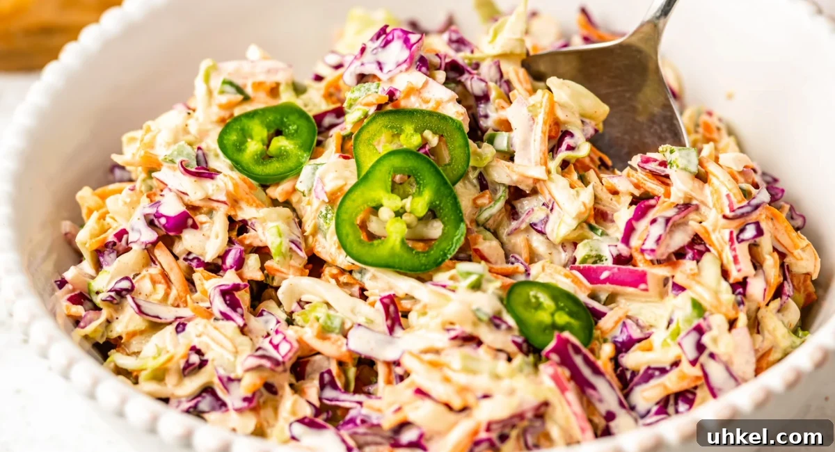 Overhead image of jalapeno coleslaw in white bowl. 