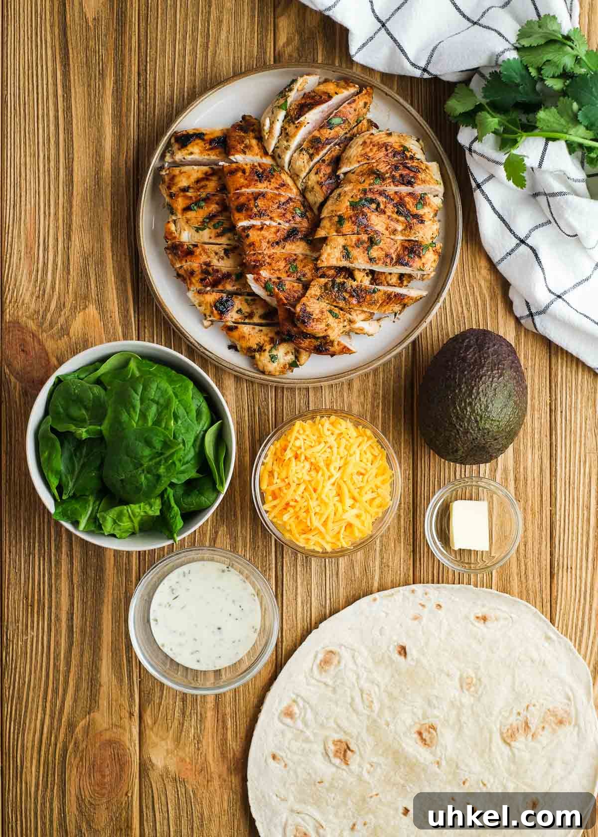 Chicken and Avocado Wrap Recipe for Quick Weeknight Meals 3 chicken avocado wrap ingredients on a wooden cutting board