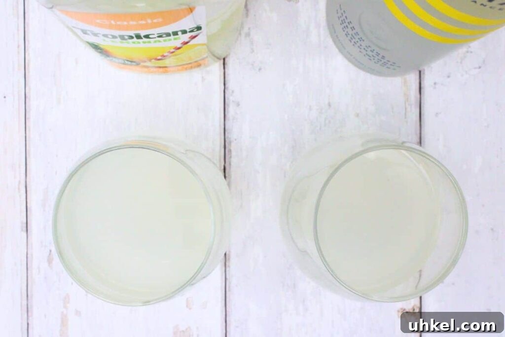 Cîroc Lemonade Spritzer Recipe — Refreshing Vodka Limonata Spritz 5 pour vodka and lemonade in stemless wine glass