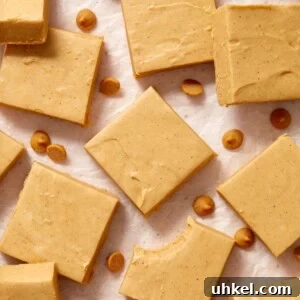Microwave peanut butter fudge cut into squares and arranged on wax paper.