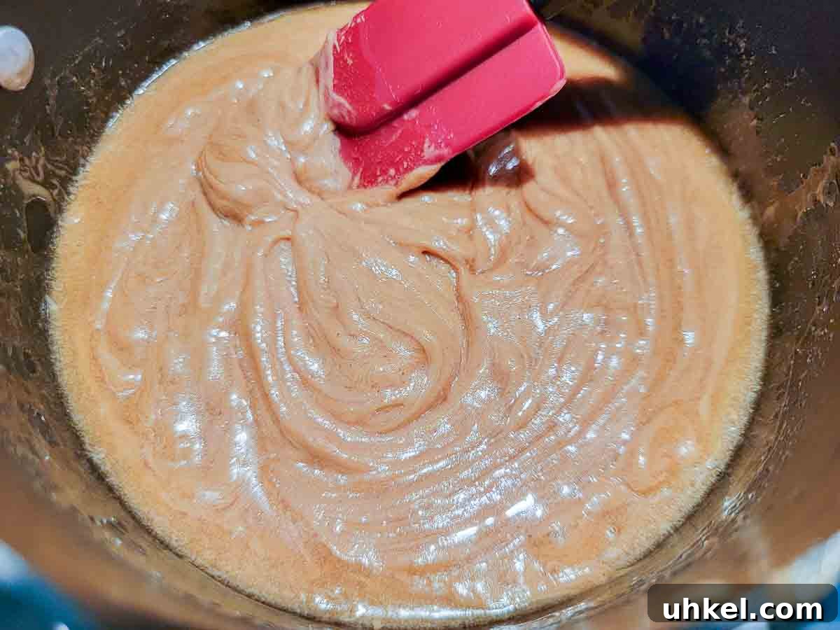 4-Ingredient Peanut Butter Oat Bars Recipe for Quick Snacks 3 peanut butter and honey cooking in a pan.