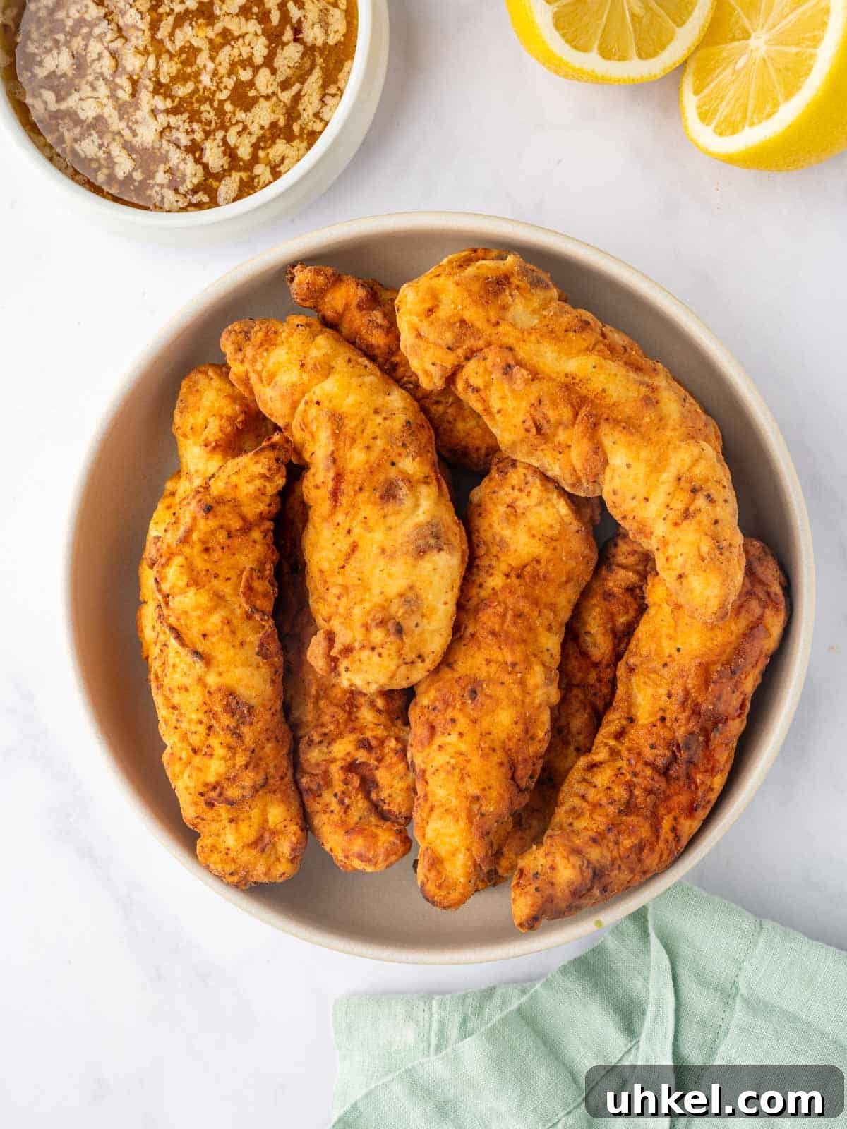 Crispy Lemon Pepper Chicken Strips Recipe 7 Cooked chicken strips in a bowl.