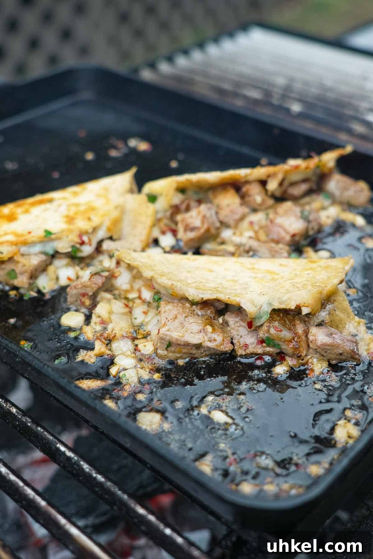 Garlic Shrimp Tacos with Spanish Flavors 7 Three Spanish garlic tacos sizzling on a griddle, with pork and cheese and garlic oil