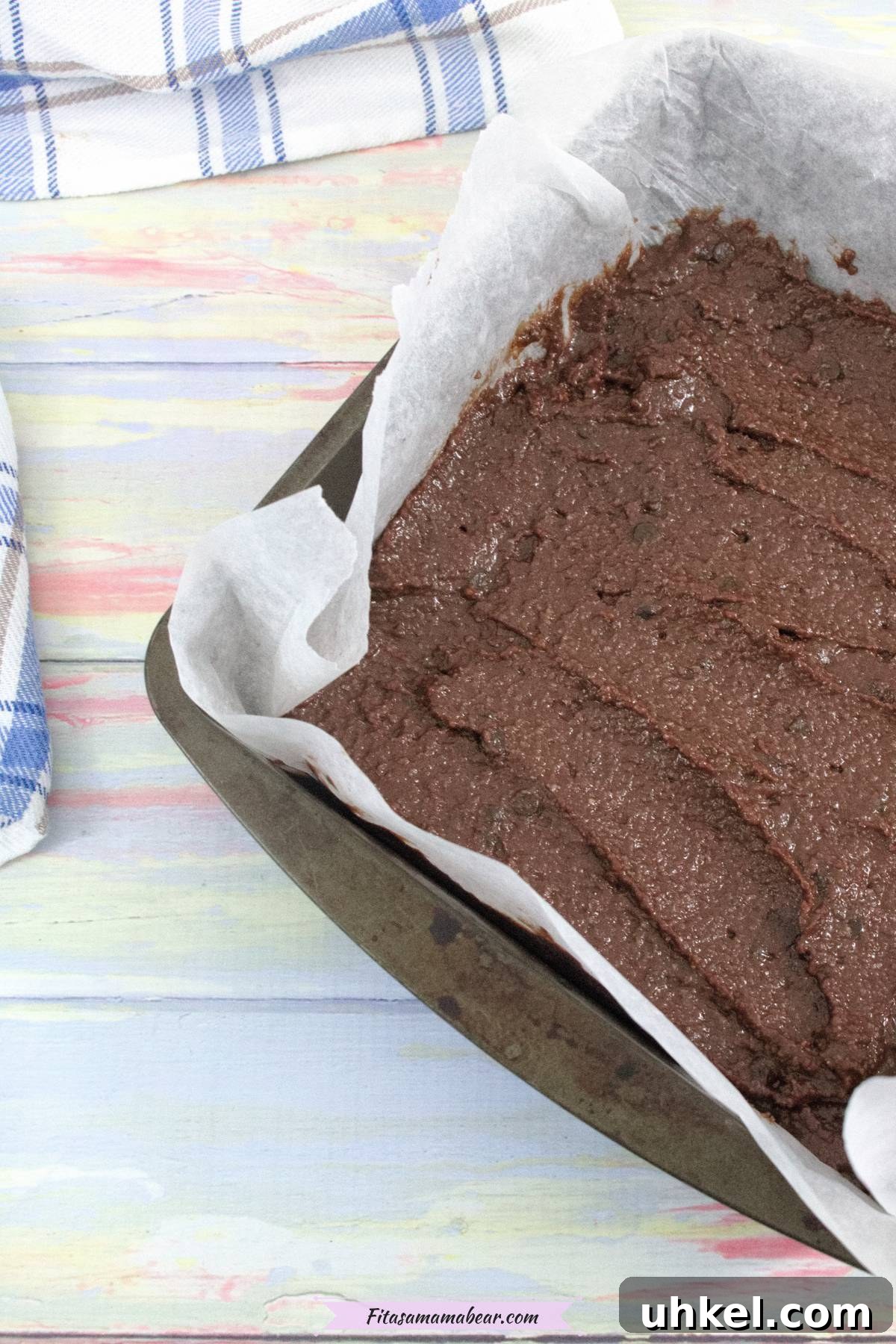 High-Protein Gluten-Free Brownies for Chocolate Lovers 7 Raw brownie batter in a baking tray lined with parchment paper