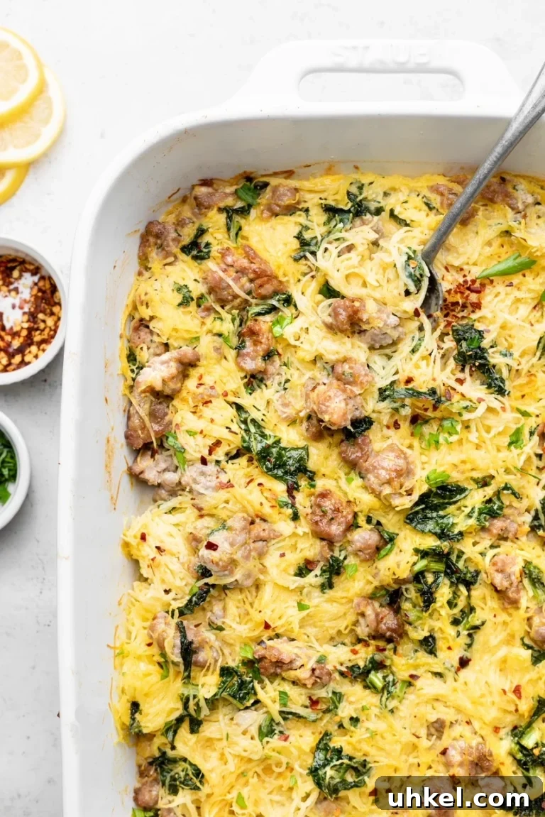 Spaghetti squash mixed with spinach and sausage in a creamy casserole. 