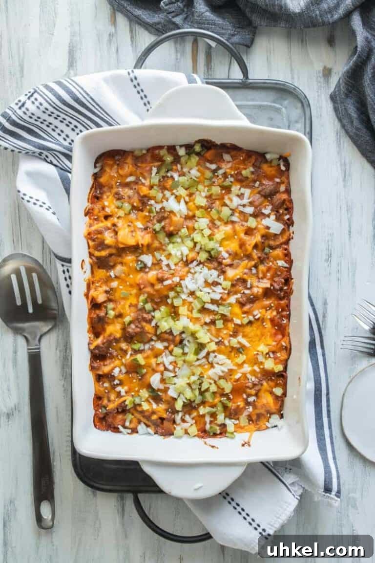 A cheeseburger casserole in a baking dish on a dinner table. 