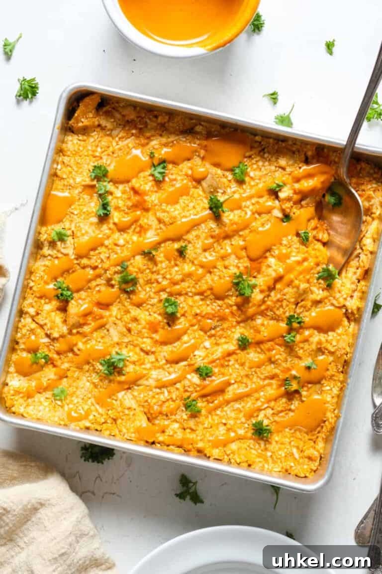 Buffalo chicken casserole topped with extra buffalo chicken sauce.