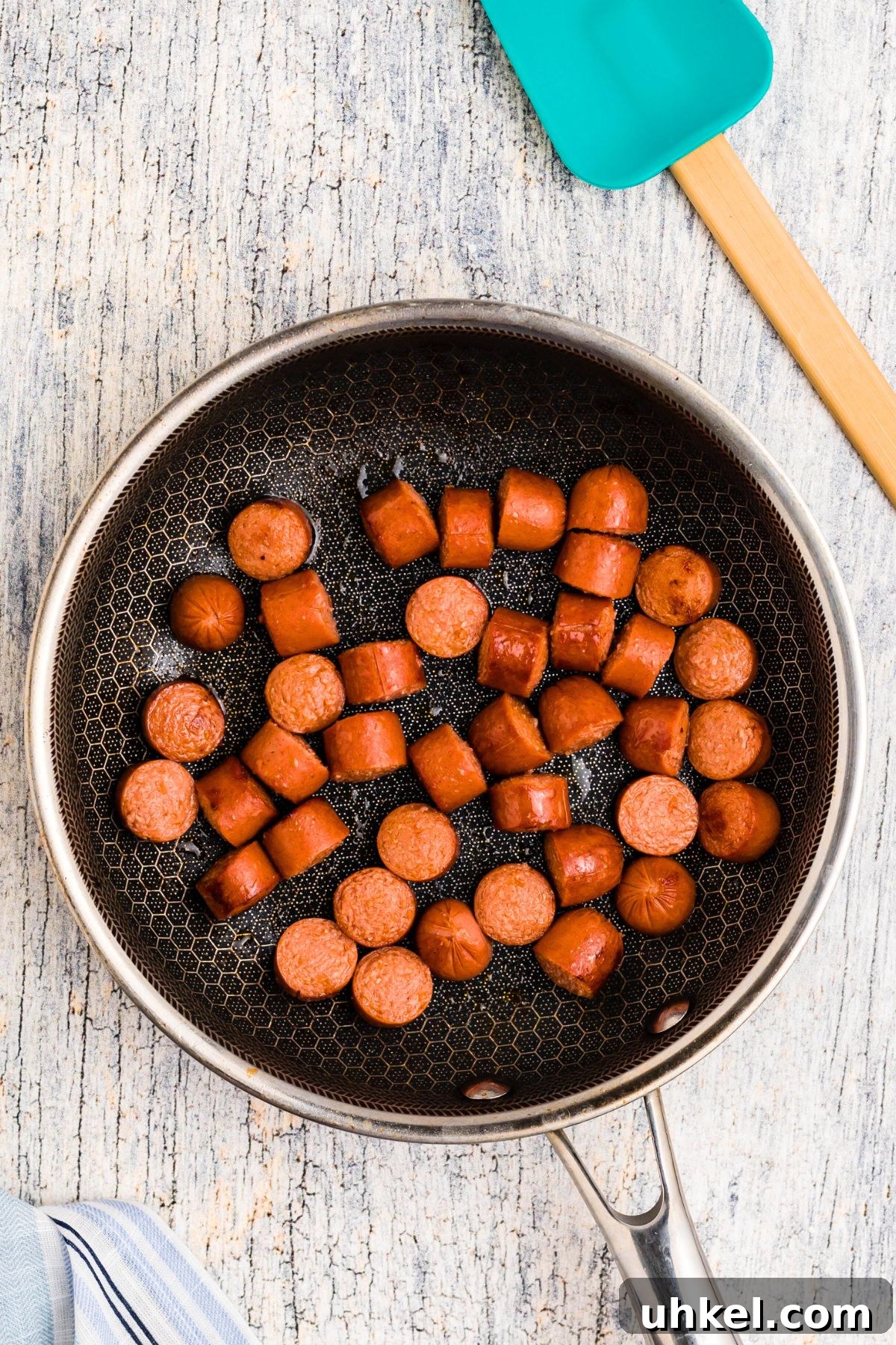 Classic Beanie Weenies Recipe with Flavorful Tomato Sauce 4 Hot dogs cut into slices, browned in a skillet.