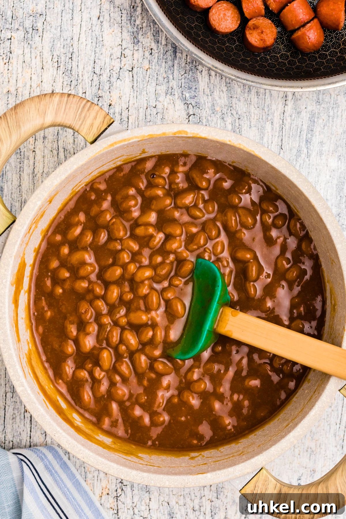 Classic Beanie Weenies Recipe with Flavorful Tomato Sauce 6 Beans and other ingredients in saucepan after simmering.