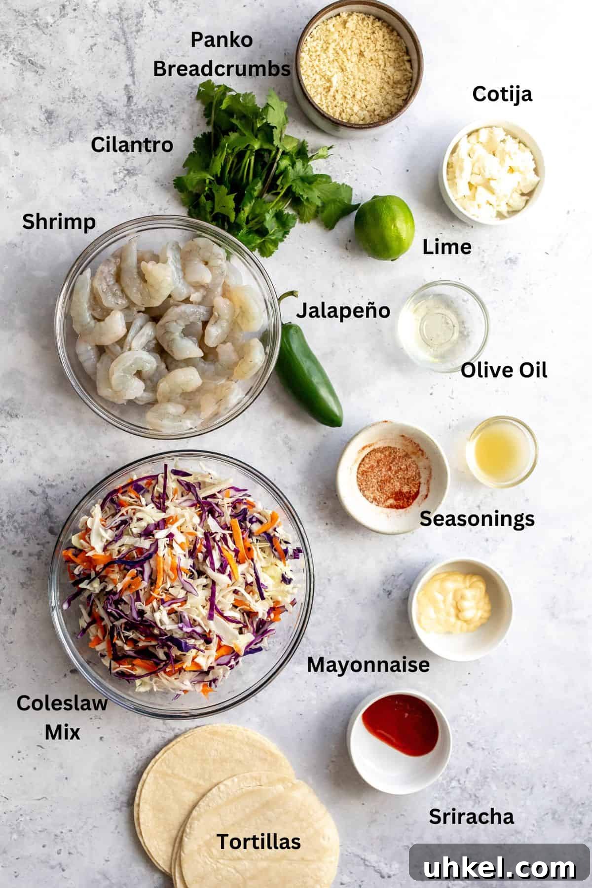 Crispy Baja Shrimp Tacos with Tangy Lime Slaw 3 Overhead photo of bowls and small plates showing the ingredients for the recipe.