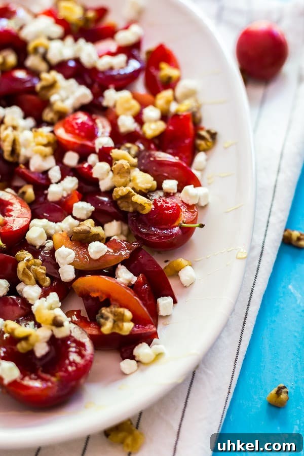 Roasted Plums with Goat Cheese and Toasted Walnuts 5 The side of a plate of plums with goat cheese and walnuts/