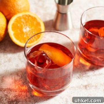 Classic Negroni Cocktail Recipe: How to Mix the Perfect Negroni 6 Two Negroni cocktails with oranges and a cocktail jigger.