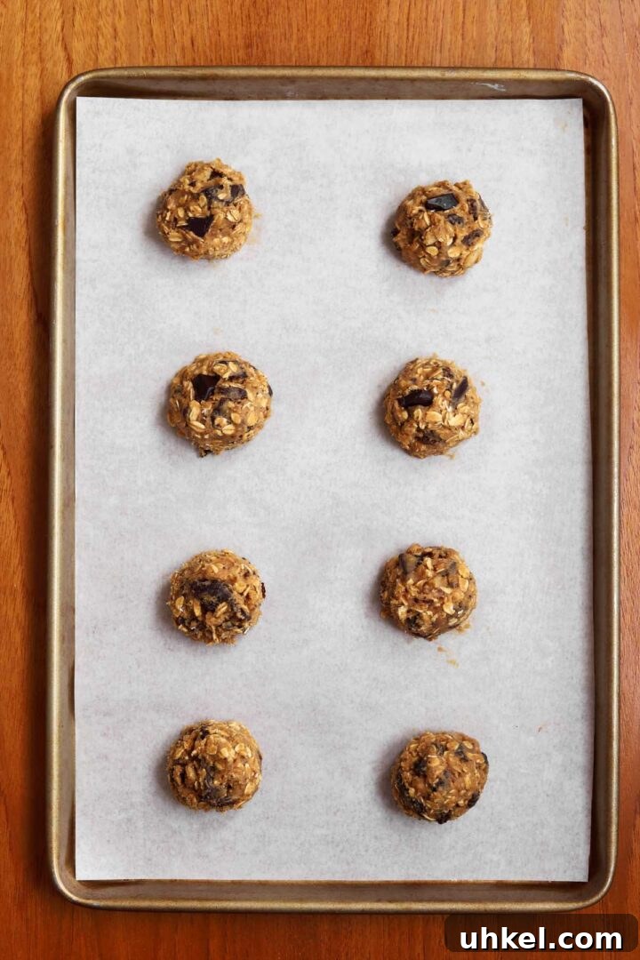 Dark Chocolate Chunk Molasses Oatmeal Cookies for Cozy Baking 7 dark chocolate chunk molasses oatmeal cookie dough on baking sheet before baking in the oven