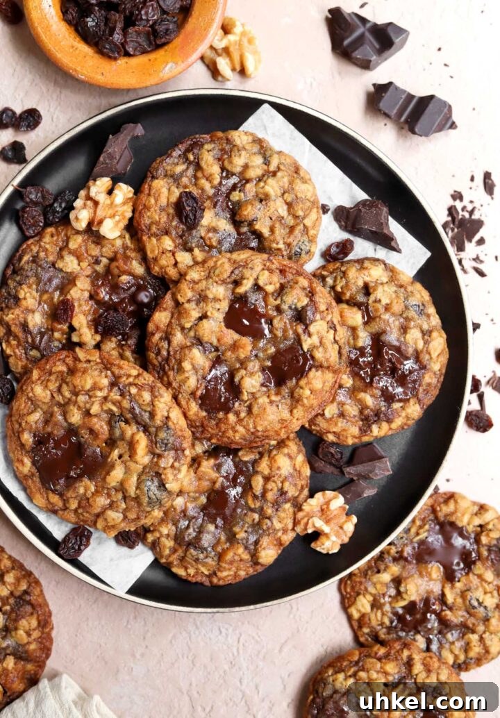 Dark Chocolate Chunk Molasses Oatmeal Cookies for Cozy Baking 9 top view of dark chocolate chunk molasses oatmeal cookies piled up on a black plate