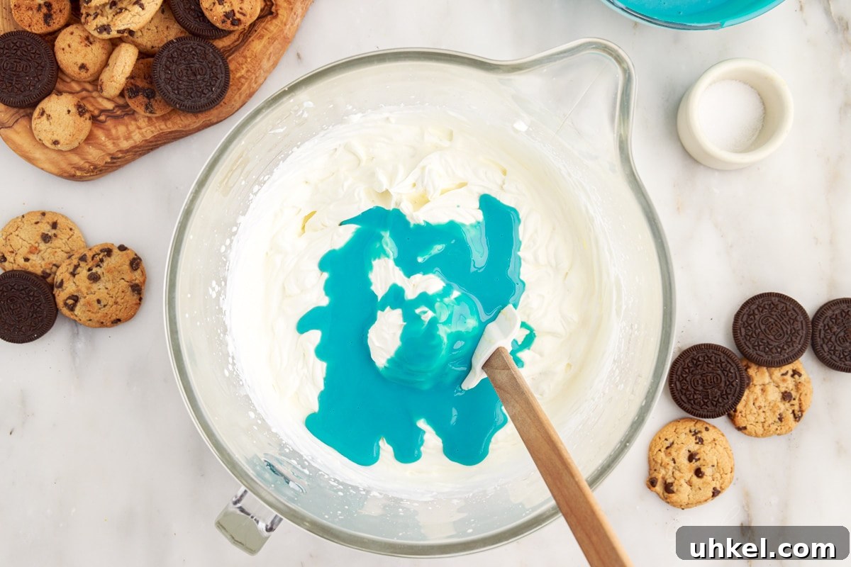 Blue condensed milk mixture added to heavy cream.