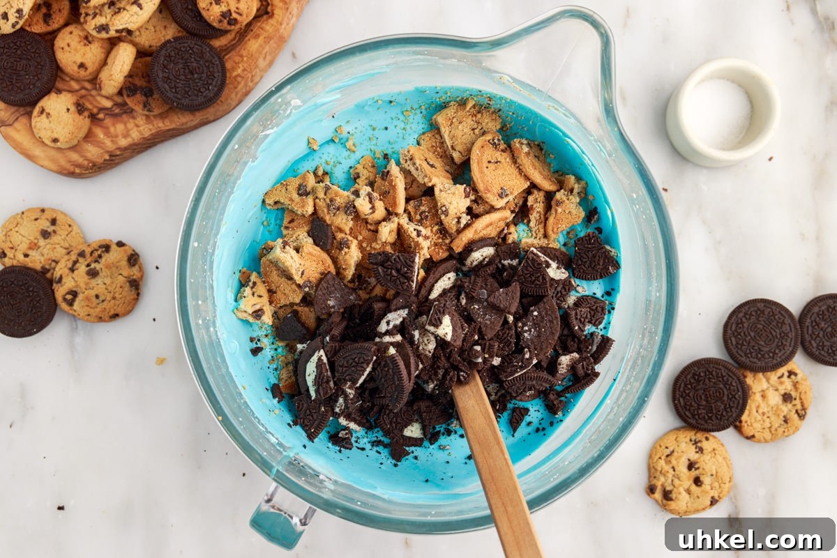 Chopped cookies added to the whipped mixture to make Cookie Monster Ice Cream.
