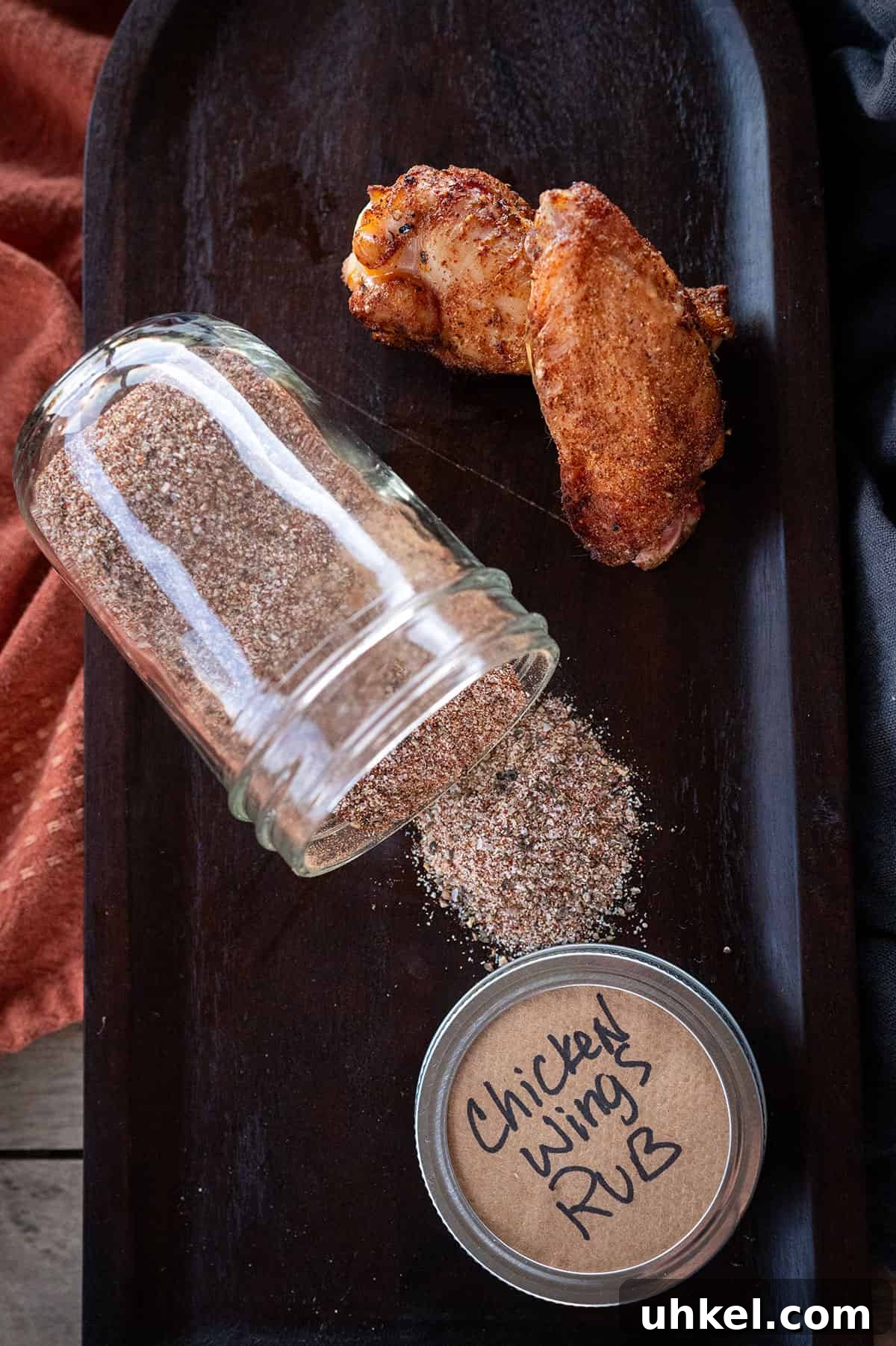 Savory Homemade Dry Rub Recipe for Crispy Chicken Wings 2 Chicken wing rub on platter with two smoked wings.