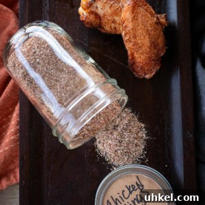 Savory Homemade Dry Rub Recipe for Crispy Chicken Wings 13 Chicken wing rub on platter with two smoked wings.