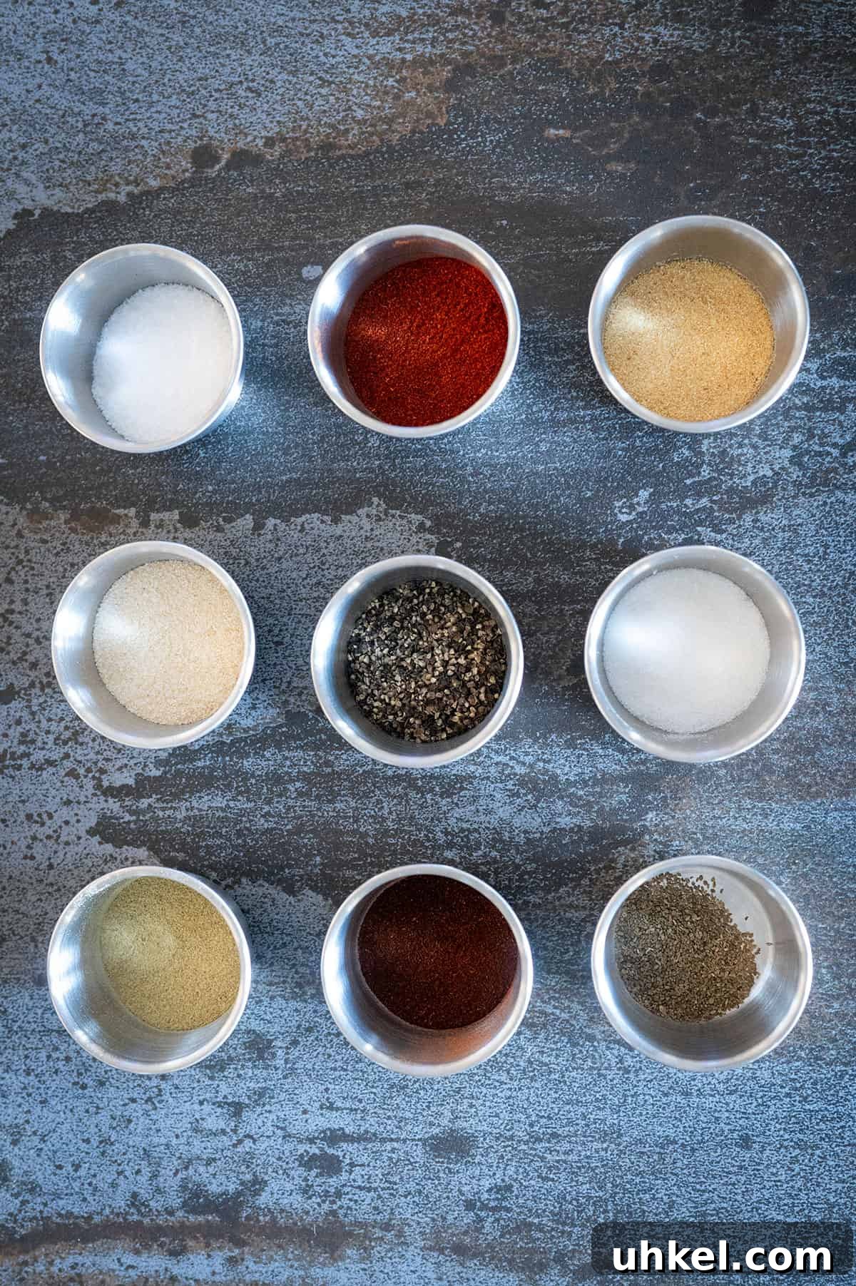 Savory Homemade Dry Rub Recipe for Crispy Chicken Wings 3 Bowls of spices used to make chicken wing dry rub.