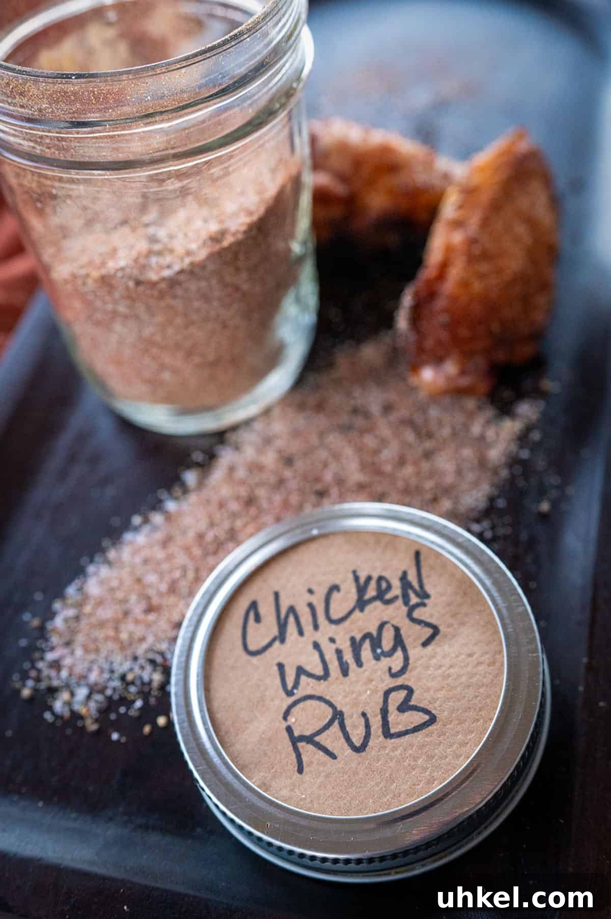 Savory Homemade Dry Rub Recipe for Crispy Chicken Wings 7 Chicken wing rub on platter with two smoked wings.