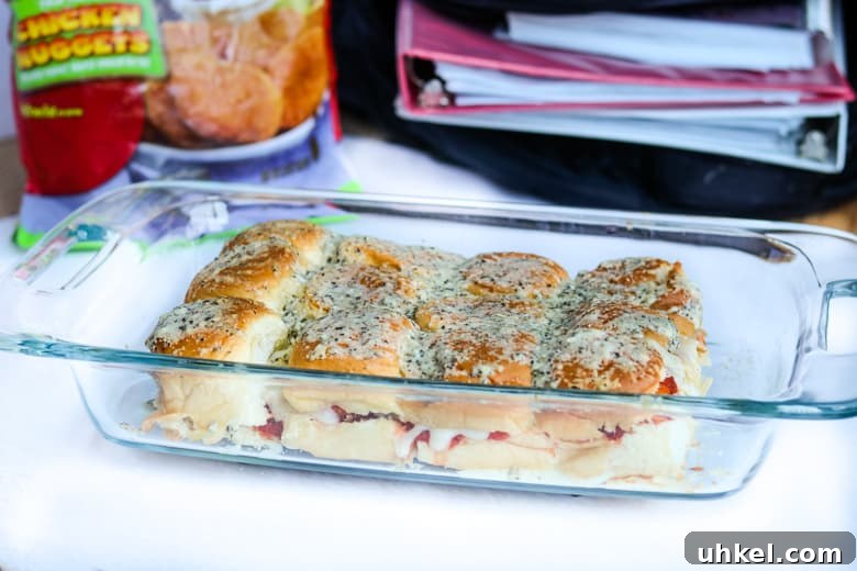 Chicken Parmesan Sliders Recipe: Crispy Mini Sandwiches 10 Hawaiian roll chicken parm sliders in 9x13 casserole dish.