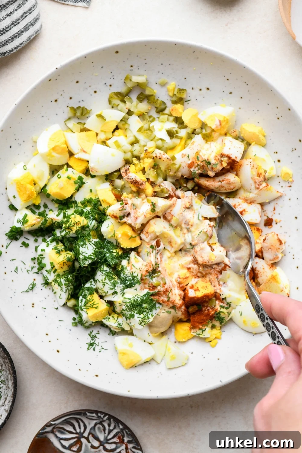 Creamy Deviled Egg Salad Recipe — Ready in 30 Minutes 10 How to make deviled egg salad: A spoon mixing together egg salad.
