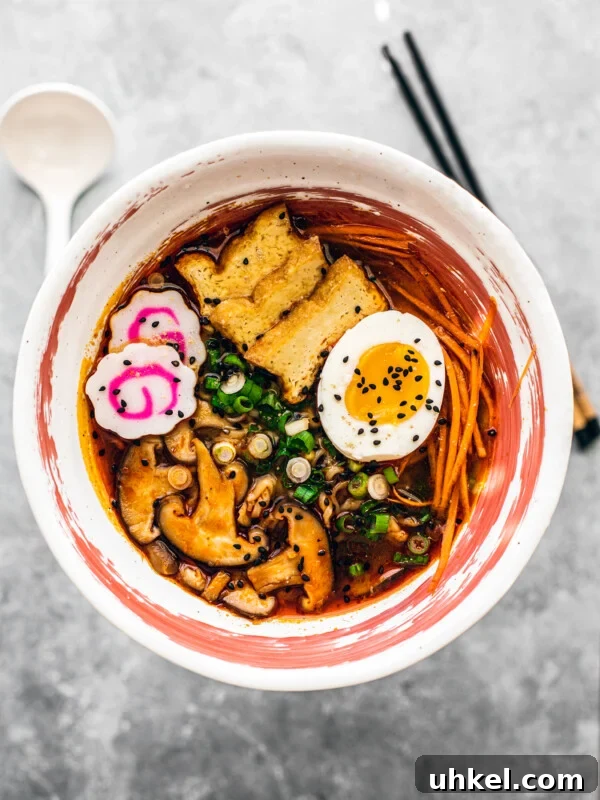 Homemade Ramen Bowl Recipe: Savory Broth & Tasty Toppings 14 Bowl of shoyu ramen with mushrooms, scallions, narutomaki, egg, and carrots.