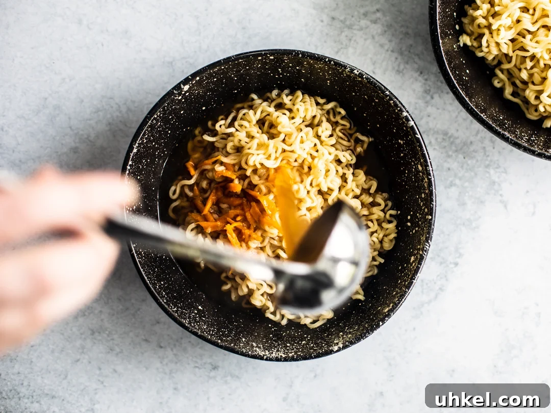 Homemade Ramen Bowl Recipe: Savory Broth & Tasty Toppings 8 Broth being poured over Ramen noodles in a bowl.