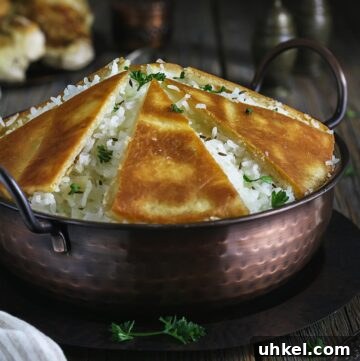Crispy Tahdig with Naan Crust — Pan-Fried Persian Rice 12 A close up of the bowl with rice tahdig on a rustic wooden table