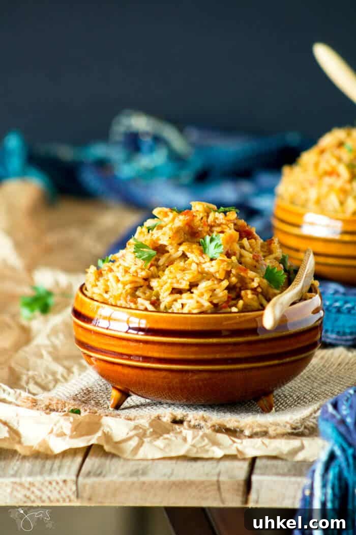 A front shot of a bowl of jollof rice on a wooden background.