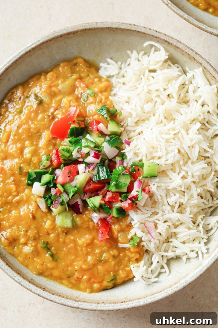 Authentic Masoor Dal (Red Lentil) Recipe for Perfect Flavor 18 A bowl with rice and Masoor Dal topped with crunchy vegetables.
