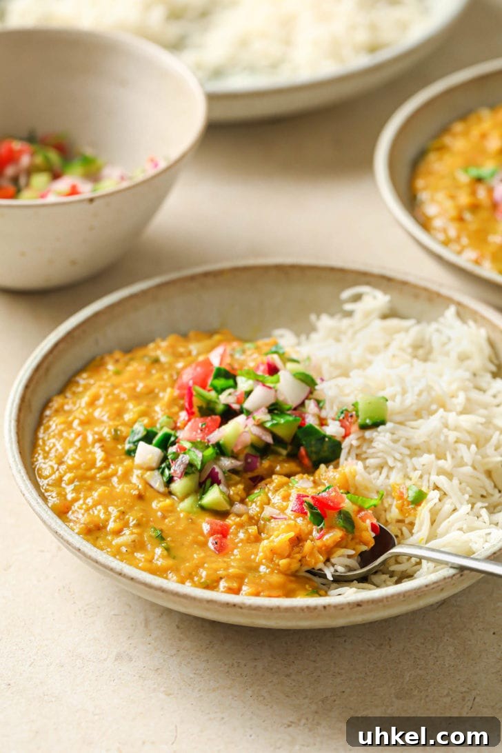 Authentic Masoor Dal (Red Lentil) Recipe for Perfect Flavor 19 A bowl with rice and Masoor Dal topped with crunchy vegetables.