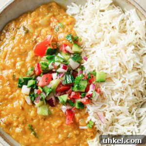 Authentic Masoor Dal (Red Lentil) Recipe for Perfect Flavor 21 A bowl with rice and Masoor Dal topped with crunchy vegetables.
