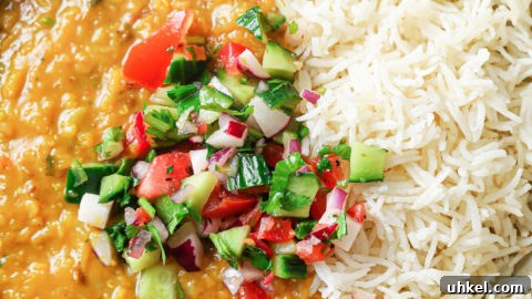 Authentic Masoor Dal (Red Lentil) Recipe for Perfect Flavor 28 A bowl with rice and Masoor Dal topped with crunchy vegetables.