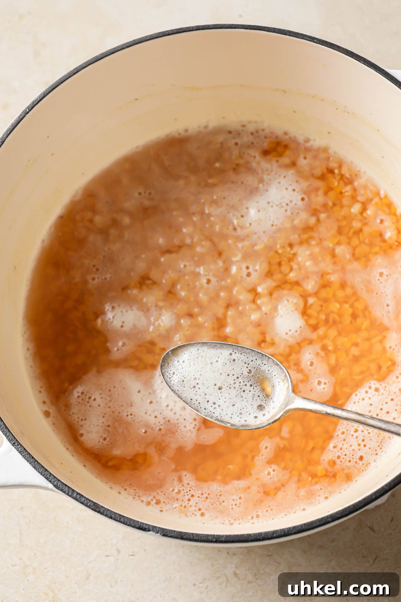 Authentic Masoor Dal (Red Lentil) Recipe for Perfect Flavor 9 Removing scum from cooking red lentils.