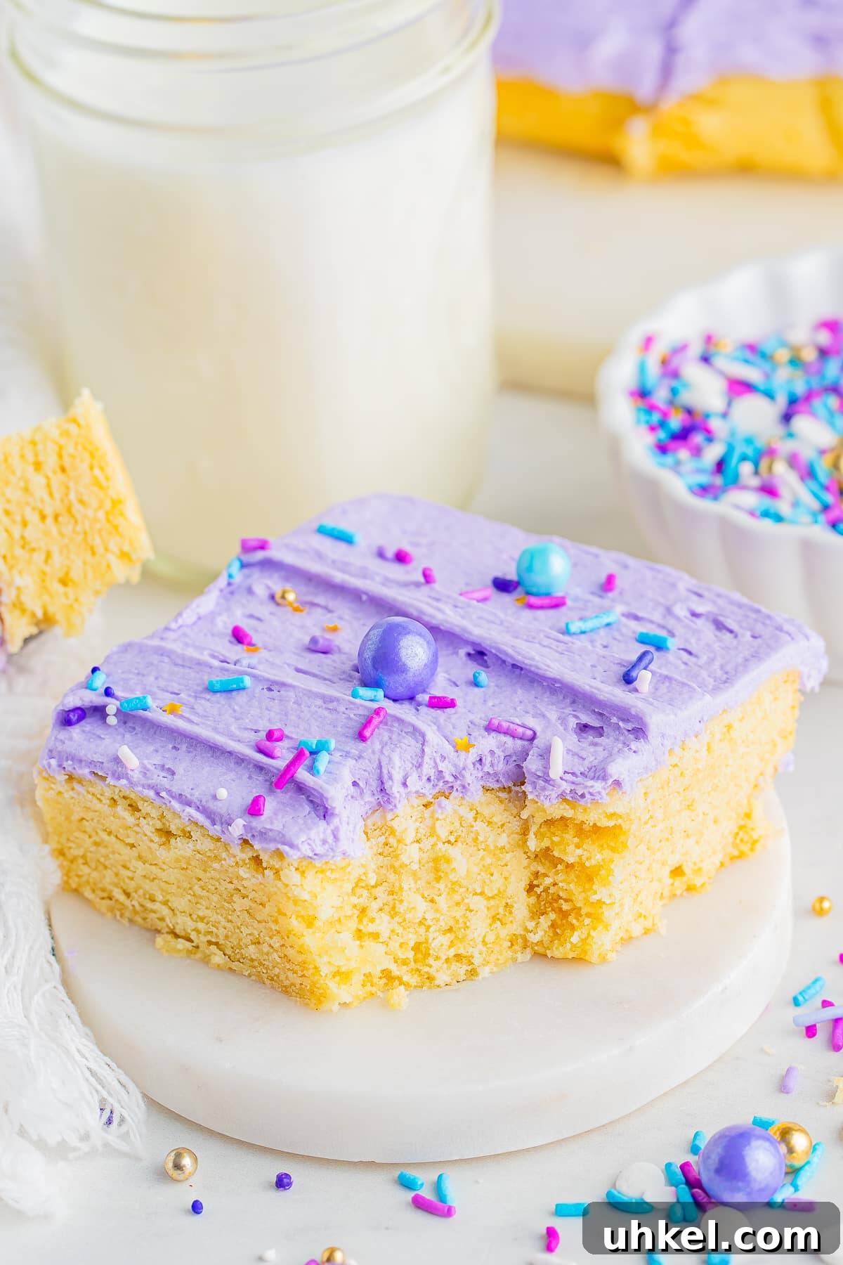 Chewy Frosted Sugar Cookie Bars: Simple Homemade Recipe 9 A frosted sugar cookie bar with a bite taken out on a small marble plate
