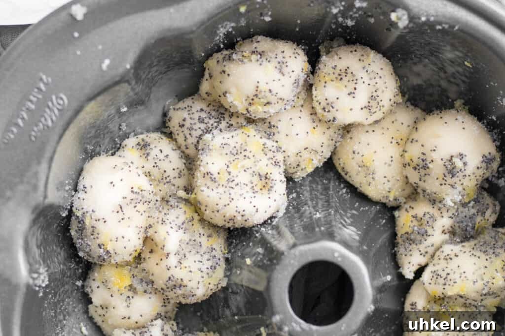 Lemon Poppy Seed Monkey Bread Recipe — Light Citrus Pull‑Apart Bread 8 lemon poppy seed covered dough balls in a bundt pan