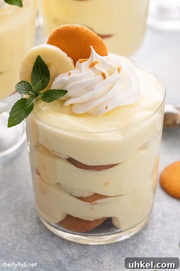 Homemade Banana Pudding Recipe with Creamy Vanilla Custard 6 layered banana pudding in parfait glass with whipped cream