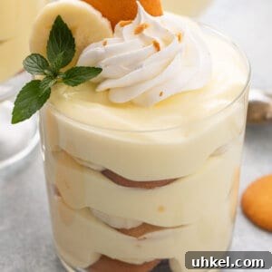 Homemade Banana Pudding Recipe with Creamy Vanilla Custard 7 layered banana pudding in parfait glass with whipped cream