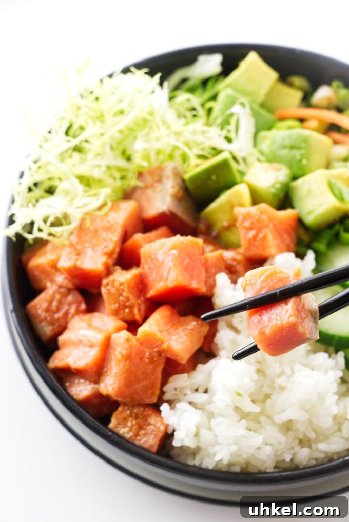 Spicy Salmon Sushi Bowl Recipe for Flavorful Weeknight Meals 4 A bowl of spicy sushi, chopsticks lifting a salmon bite
