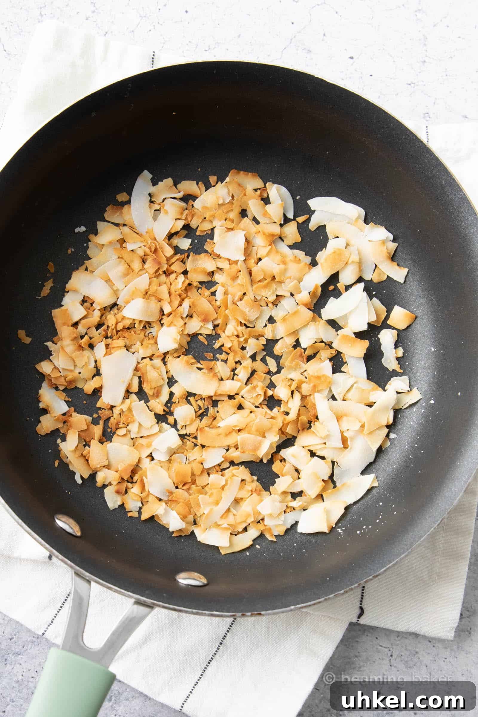 How to Toast Coconut Perfectly: Quick Oven and Stovetop Methods 3 coconut in pan after using the best way to toast coconut