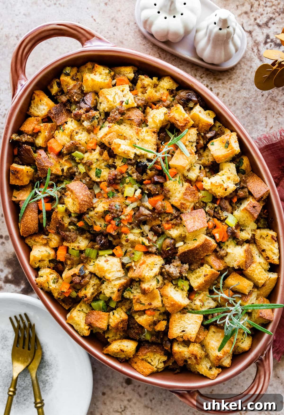 Sausage and Chestnut Ciabatta Stuffing Recipe for Holiday Tables 15 finished ciabatta bread stuffing in with sausage and chestnuts recipe. Herbs on the top and garlic on the side.