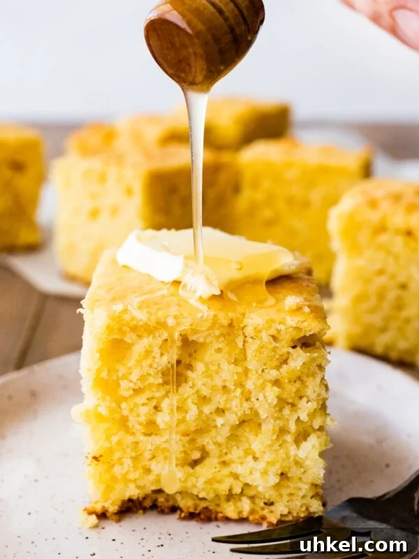Sausage and Chestnut Ciabatta Stuffing Recipe for Holiday Tables 16 Honey pouring onto a slice of sweet cornbread with butter.