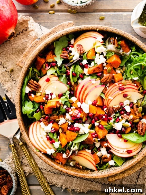 Sausage and Chestnut Ciabatta Stuffing Recipe for Holiday Tables 18 Bright fall harvest salad in a large bowl next to serving utensils.