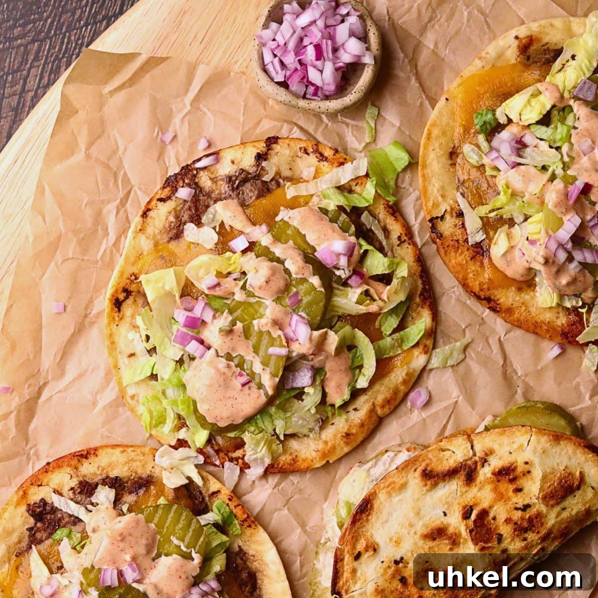 Smash Burger Tacos Recipe: Crispy Smashed Beef Tacos with Cheese 8 Smashburger tacos on a wooden cutting board.